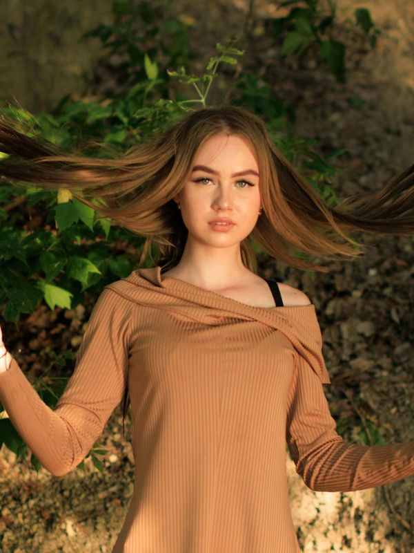 Person in a dynamic yet graceful pose suggesting movement.